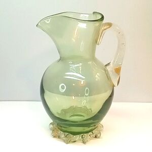 Vintage hand blown green glass pitcher, with gold fleck and applied handle.